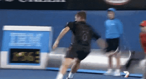 a man in a black shirt with the number 10 on the back is running on a tennis court
