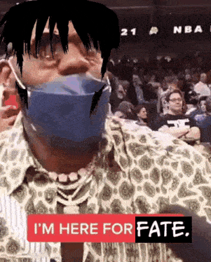 a man wearing a face mask says i 'm here for fate in front of a crowd