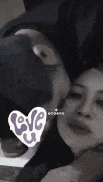 a man kissing a woman on the cheek with a heart that says love u