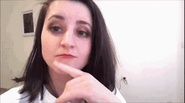 a woman with dark hair is making a funny face