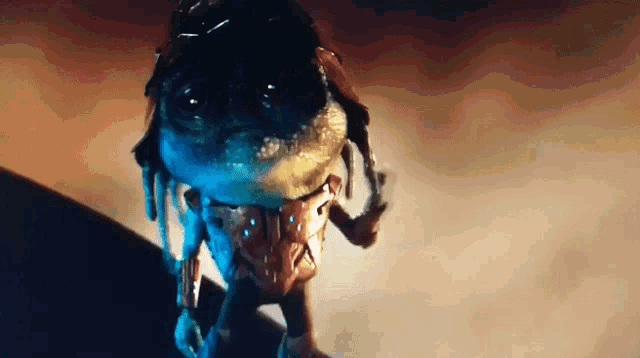 a close up of a monster 's head with a very large head