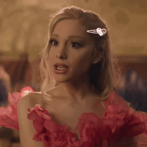 a woman in a pink dress with a heart hair clip