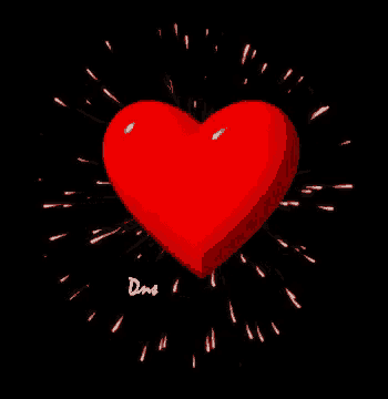 a red heart with sparks coming out of it is on a black background .