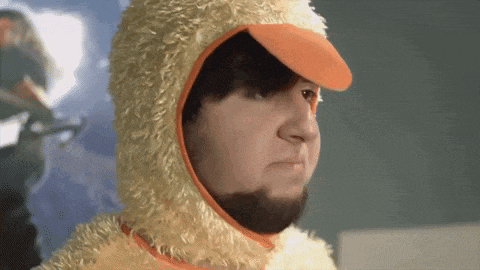 a man with a beard wears a yellow duck costume