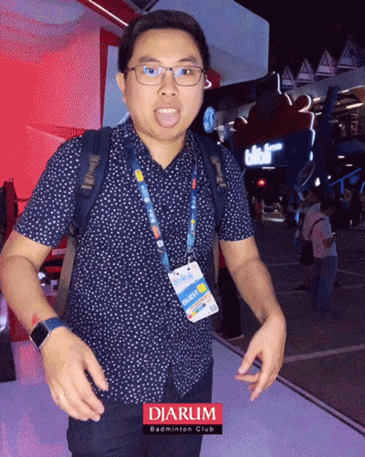 a man wearing glasses and a lanyard that says djarum