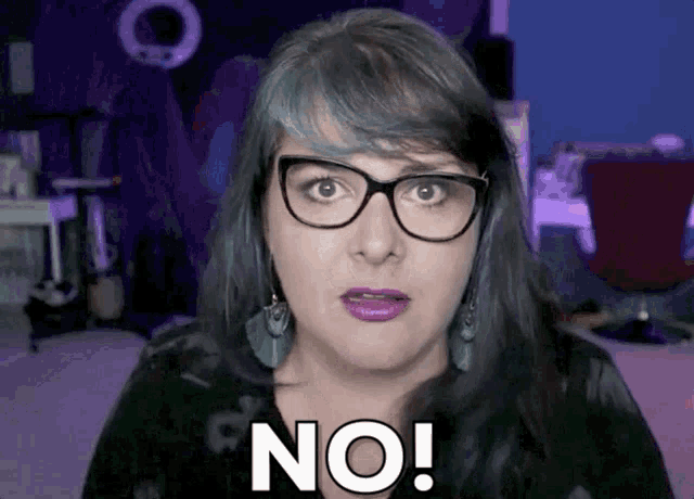 a woman with glasses and purple lips says no
