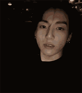 a close up of a person 's face with a hand visible