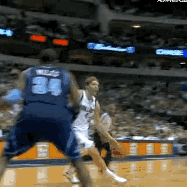 a basketball player with the number 34 on his jersey is dribbling a basketball