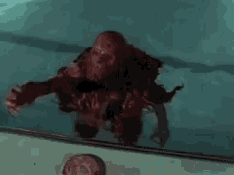 a bloody monster is standing in a swimming pool .