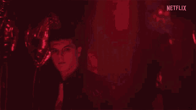 a man and a woman are looking at each other in a dark room with a netflix logo in the corner