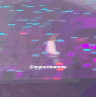 a person is riding a pink scooter on a stage with the words @imyourmoonow written on the bottom