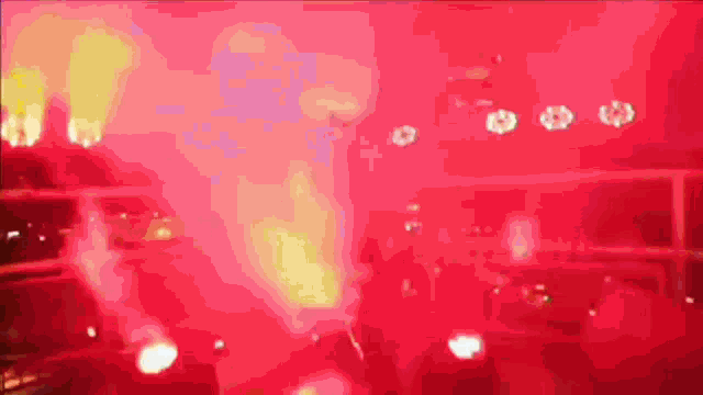 a blurred image of a red background with a few white circles