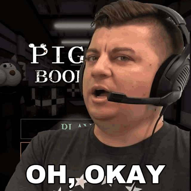 a man wearing headphones says oh okay in front of a pig boo game