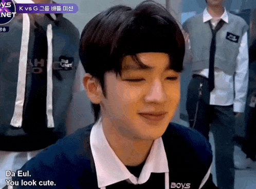 a young man wearing a headband and a shirt that says boys