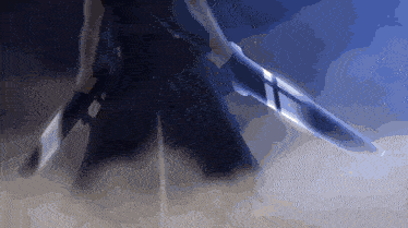 a sword with a cross on it is being held by a person