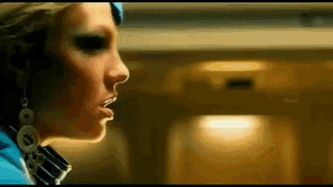 a close up of a woman 's face with a blurred background .