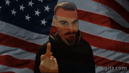 a man giving the middle finger with an american flag in the background