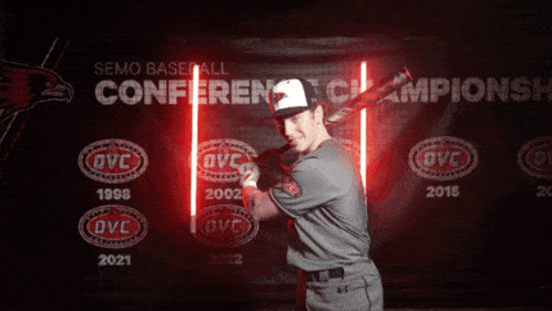 a man holding a bat in front of a banner that says semo baseball conference champions