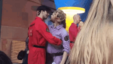 a man and a woman are hugging each other in a crowd .