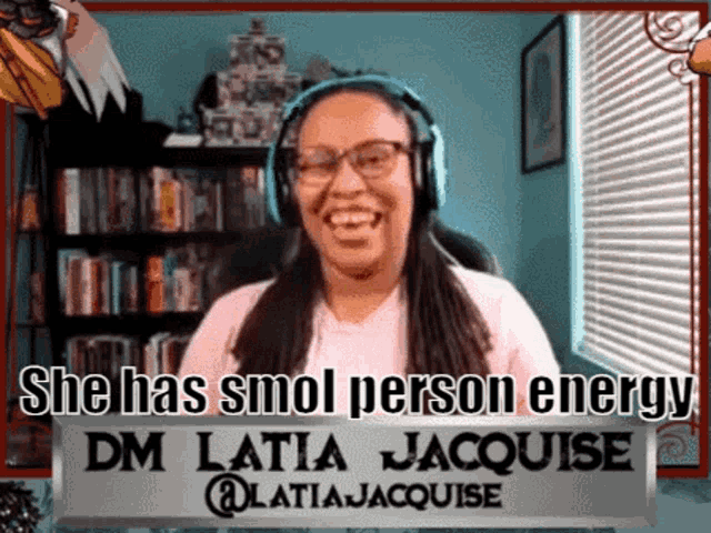 a woman with headphones and a sign that says " she has smol person energy "