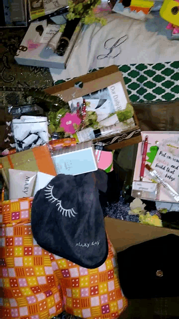 a mary kay bag sits on top of a pile of items