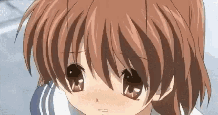 a close up of a girl 's face with brown hair and a white shirt .