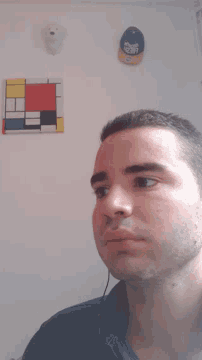 a man 's face is against a white wall with a sticker that says ' i love you '