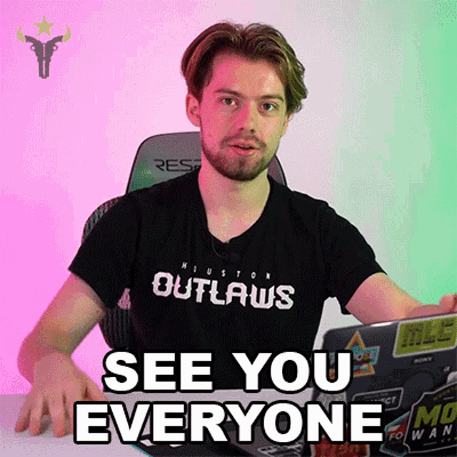 a man wearing a shirt that says outlaws on it