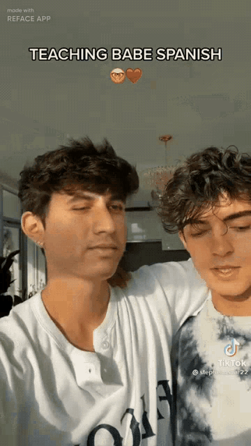 two young men are standing next to each other with the caption " teaching babe spanish "