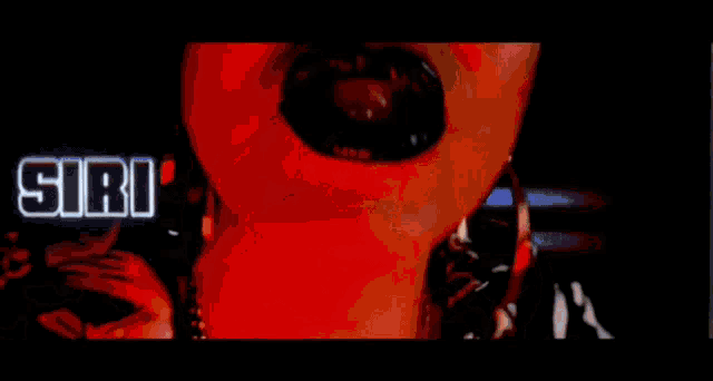 a blurred image of a person with the word siri on the bottom right