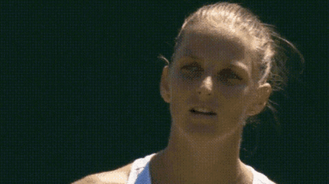 a close up of a tennis player 's face with a green background