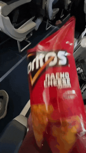 a bag of doritos nacho flavor chips on a plane