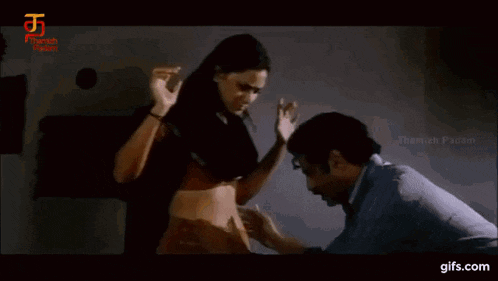 a man is touching a woman 's belly in a movie .