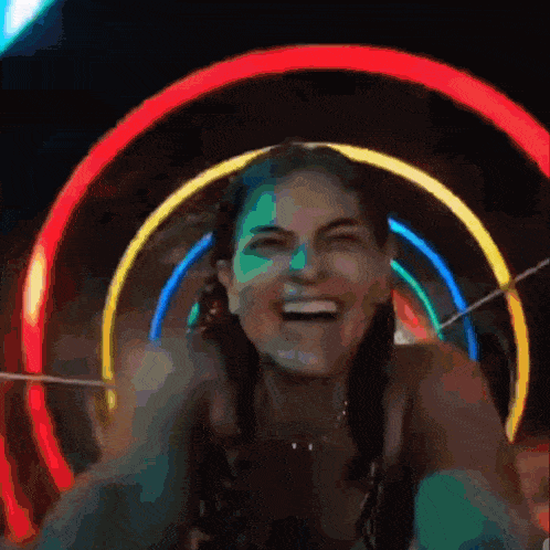 a woman is laughing while riding a roller coaster