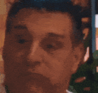 a close up of a person 's face with a blurred image of a mountain in the background
