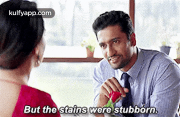 a man is giving a woman a rose and saying `` but the stains were stubborn . ''