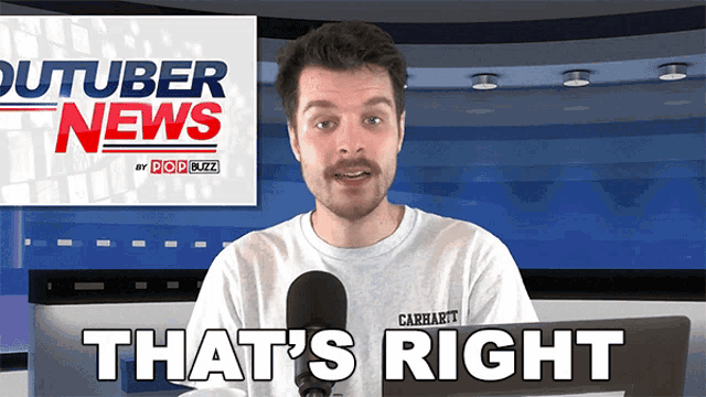 a man in a carhartt shirt is talking into a microphone in front of a youtuber news sign