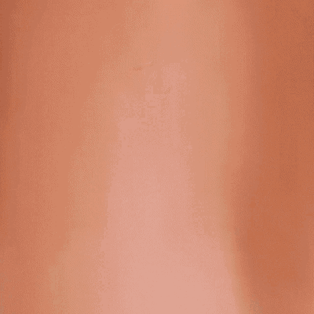 a close up of a person 's hands on a red surface .
