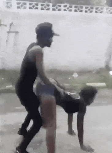 a man is riding a woman on his back on the ground .