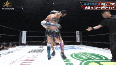 a wrestling ring with a sign that says softbank in the background
