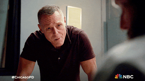 a man talking to another man with a chicagopd logo in the corner