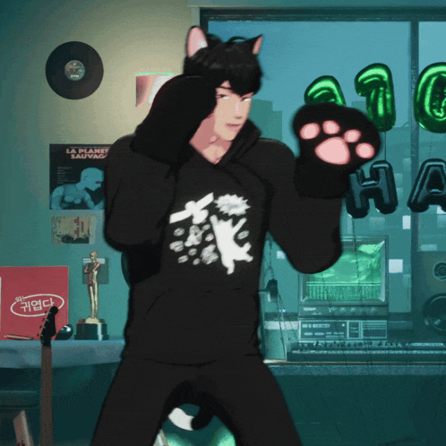 a man wearing a black hoodie with a cat on it
