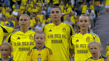 a group of women wearing yellow shirts with vi ar med dig marika written on them