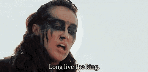 a woman with face paint on her face is saying `` long live the king . ''