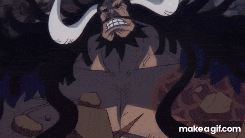a cartoon character with long horns and a beard is laying on a rock .