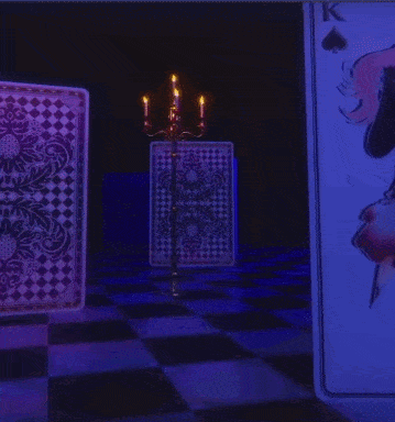 a girl with pink hair stands in front of a playing card