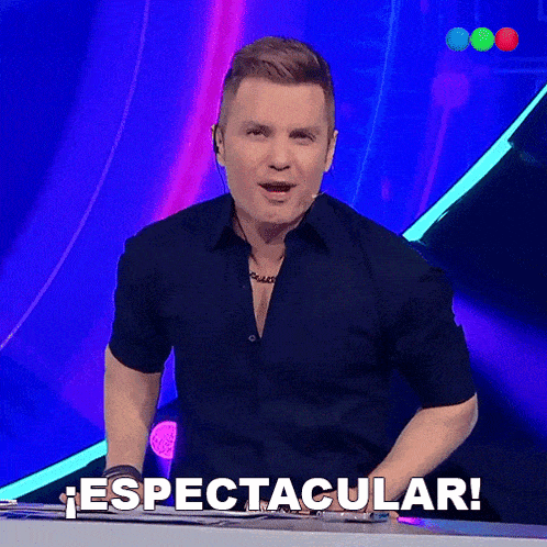 a man in a black shirt stands in front of a sign that says spectacular