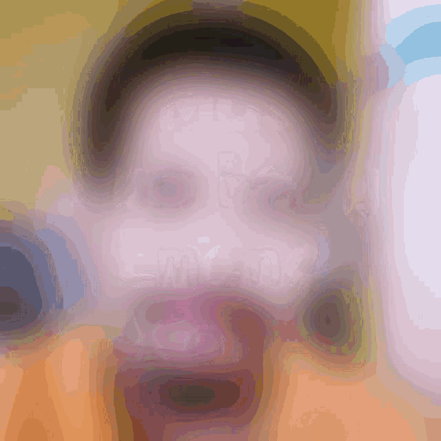 a blurry picture of a person 's face with a yellow and orange background