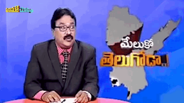a man in a suit and tie is standing in front of a map with the word telugu on it
