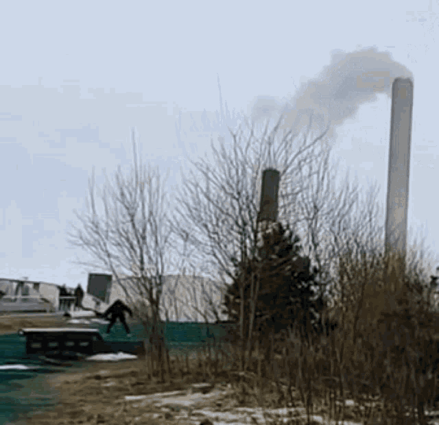 smoke is coming out of a chimney in the background